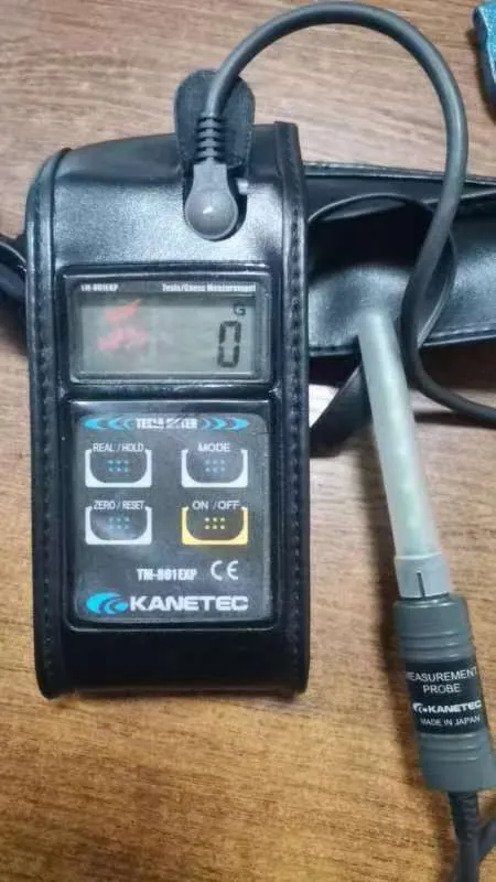 Handheld gauss meter with Hall probe on its charging dock