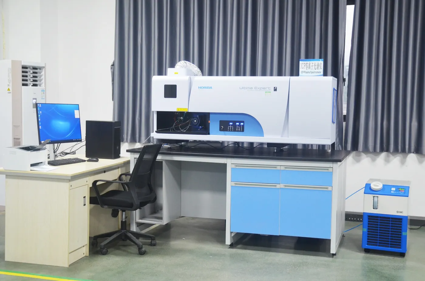 Inductively coupled plasma optical emission spectrometer on a laboratory bench